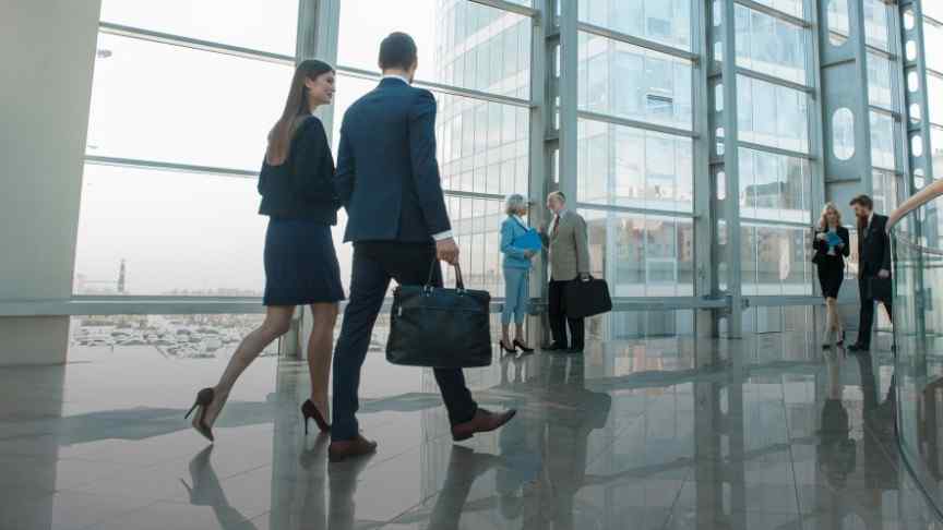 business people walking in a glass-door office