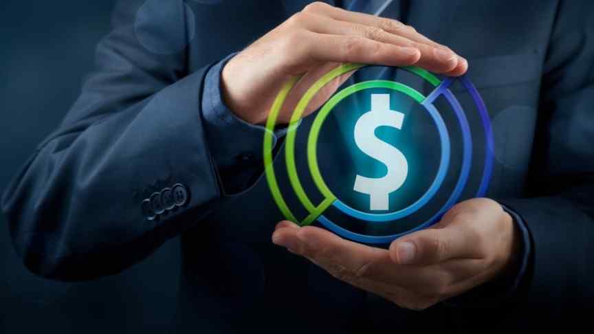 masculine hands in suit holding dollar sign in blue and green ring