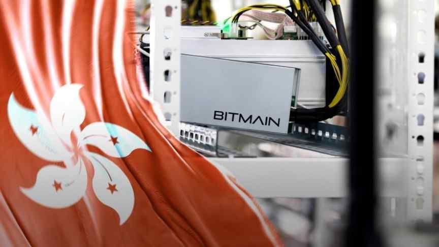 Bitmain logo on mining rig with yellow-black cables going out of it, Hong Kong flag