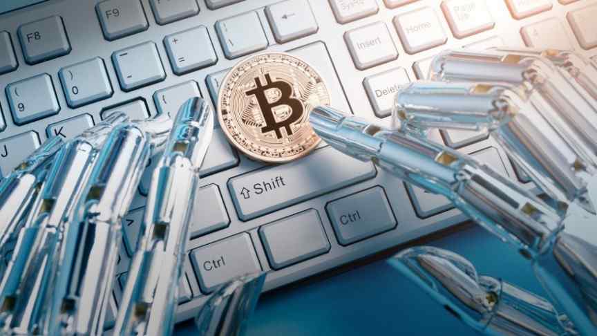 gold bitcoin on white key board, silver robot fingers