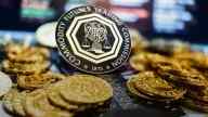 CFTC logo on coin, surrounded by gold bitcoins, blurry lights behind