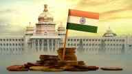 India's flag in the middle of a stack of coins, on background of Indian government building