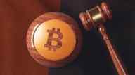 A gavel and the Bitcoin logo