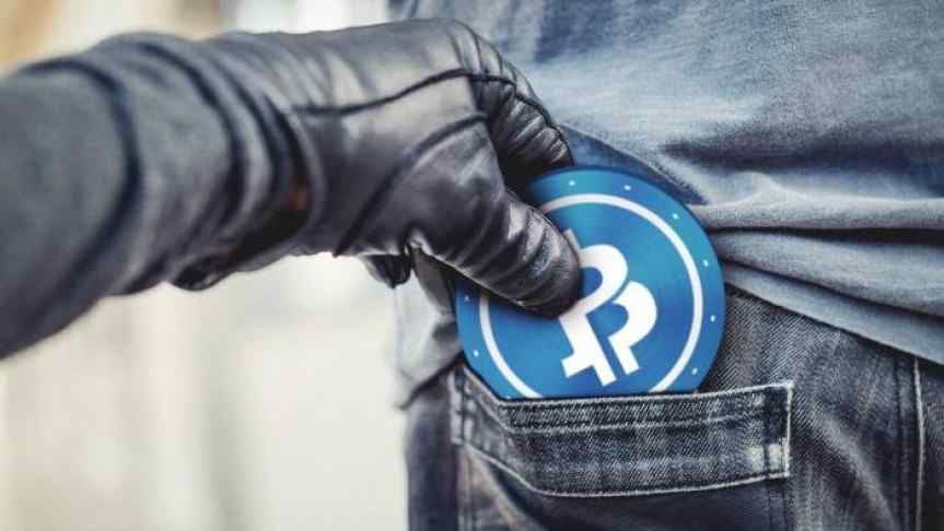 Hand in leather glove smuggling a Bitcoin from a pocket