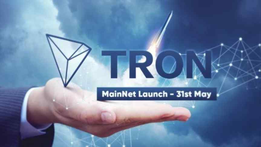 Illustration of a hand showing the Tron logo and the announcement of its MainNet launch