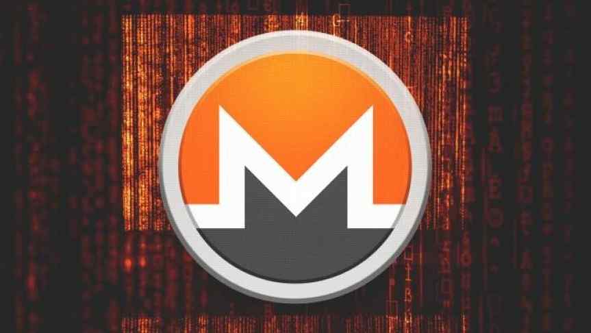 Monero enlarged logo on a stage, in front of red curtains. 