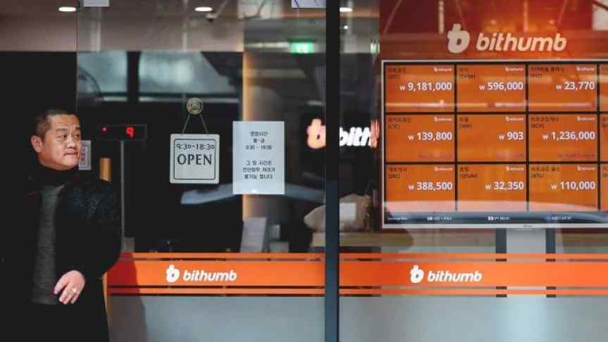 Korean man in front of a Bithumb office