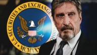 John McAfee in a suit and tie, behind him the U.S. Securities and Exchange Commission logo