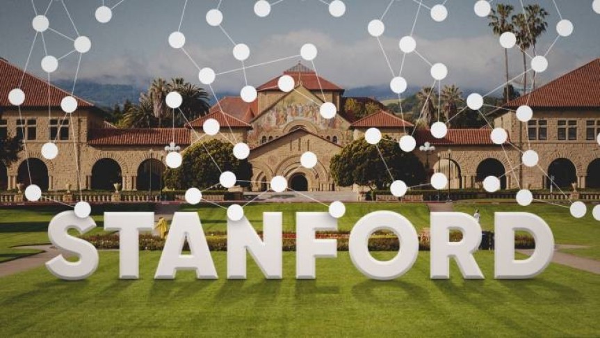 statue of Stanford name in white letters on Stanford lawn in front of Stanford university complex. Connected white does floating.