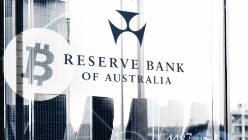 Black and white picture with Bitcoin logo and Reserve Bank of Australia name and logo on background of office buildings