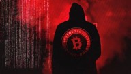 Man in black and hood shown from the back, Bitcoin logo in red on his back, red web and fog in background
