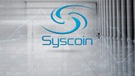Syscoin name and logo in blue on grey background showing large foyer and market graph