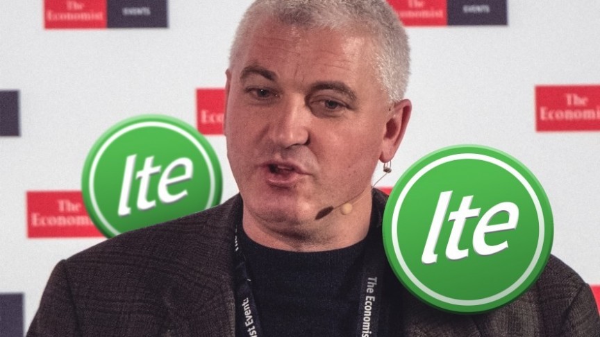 Joe Haslam mid-speech on The Economist background, ITE tokens in green on his right and left