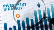 Investment Strategy, Bitcoin logo and graphs on paper, seen through magnifying glass