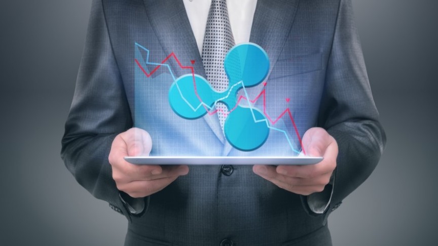 man in suit holding glowing Ripple and Graph