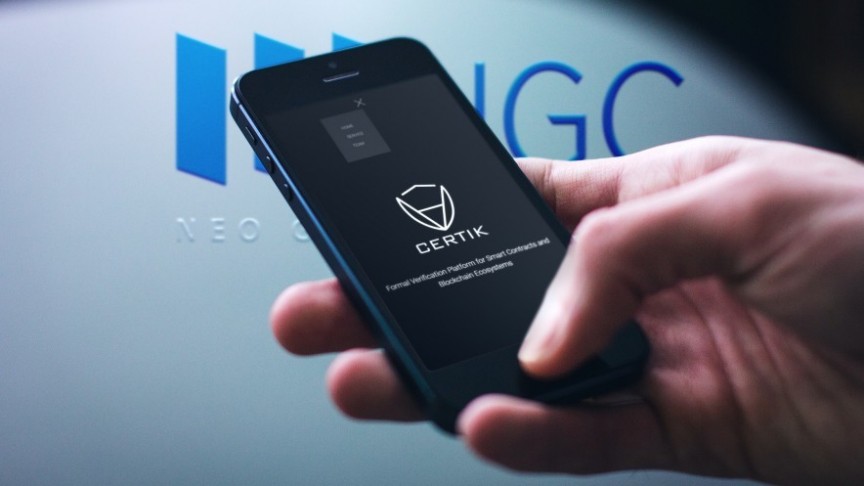 hand holding phone showing Certik name and logo, in the background NEO Global Capital (NGC) sign