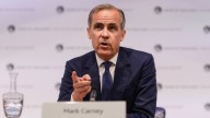 MArk Carney in dark-blue suit and tie, speaking at the G20 meeting, hand raised, pointing finger at camera