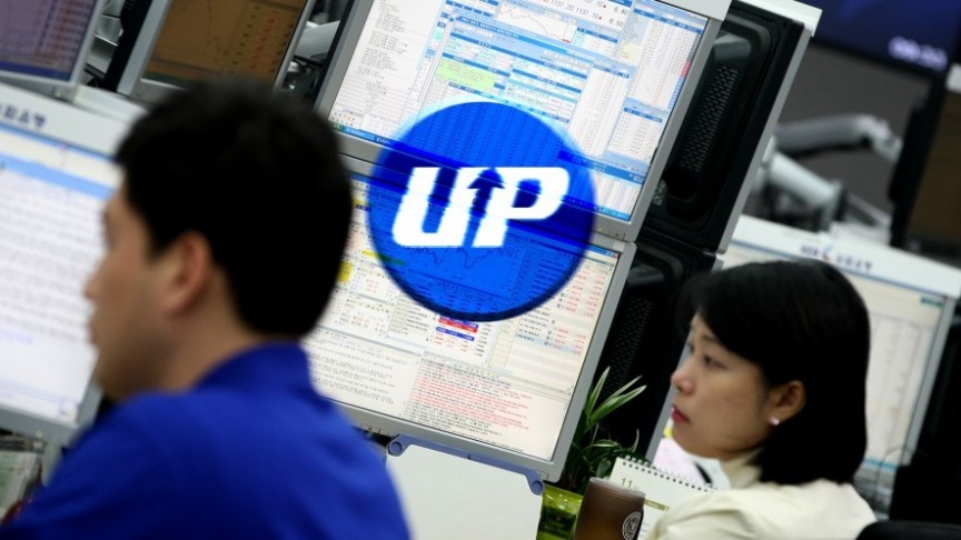 UPbit logo in blue on background of screens and two korean people