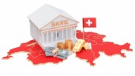 Bank white building on red Switzerland map and flag, bills, coins and gold bars in front of stairs