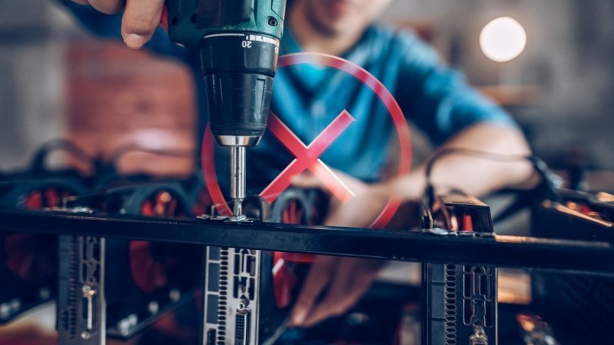 man drilling, red x sign in background